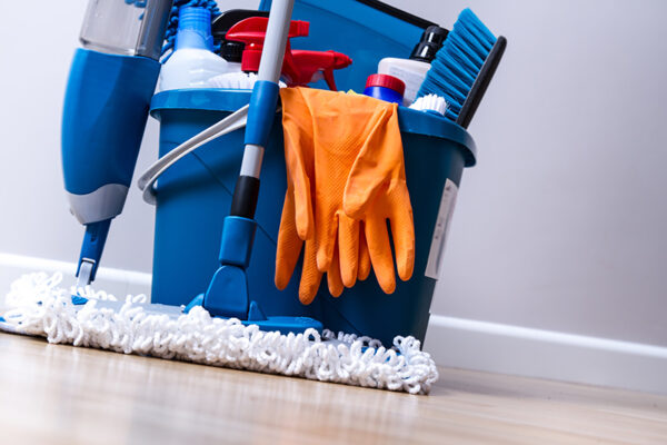 Cleaning service. Bucket with sponges, chemicals bottles and mop